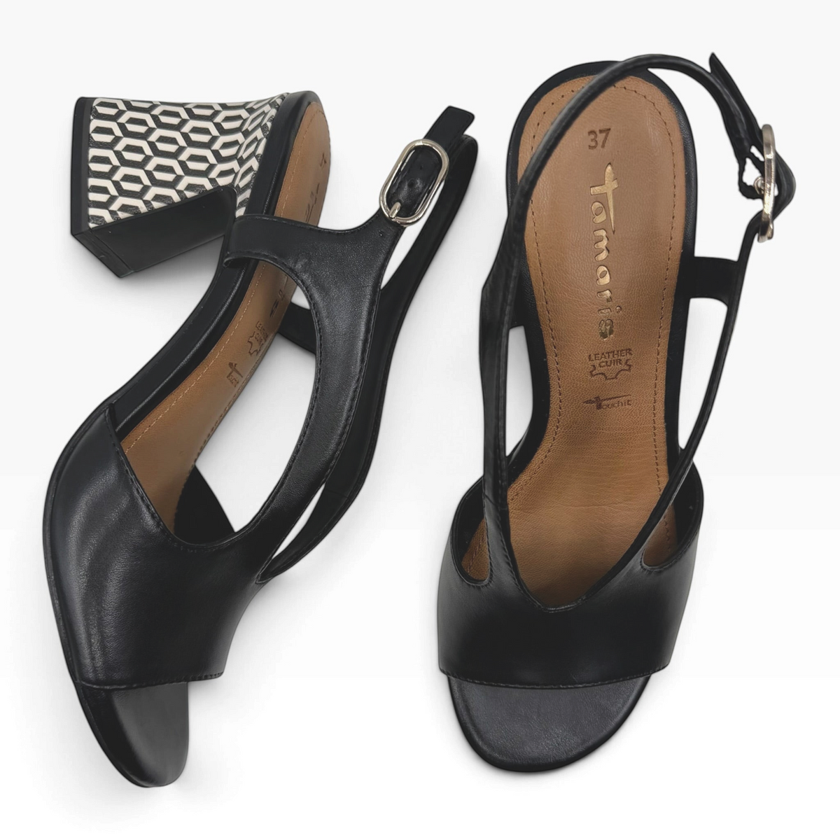 The Shoe Shop black leather heeled sandals with a sculptural block heel featuring a geometric pattern and slingback.