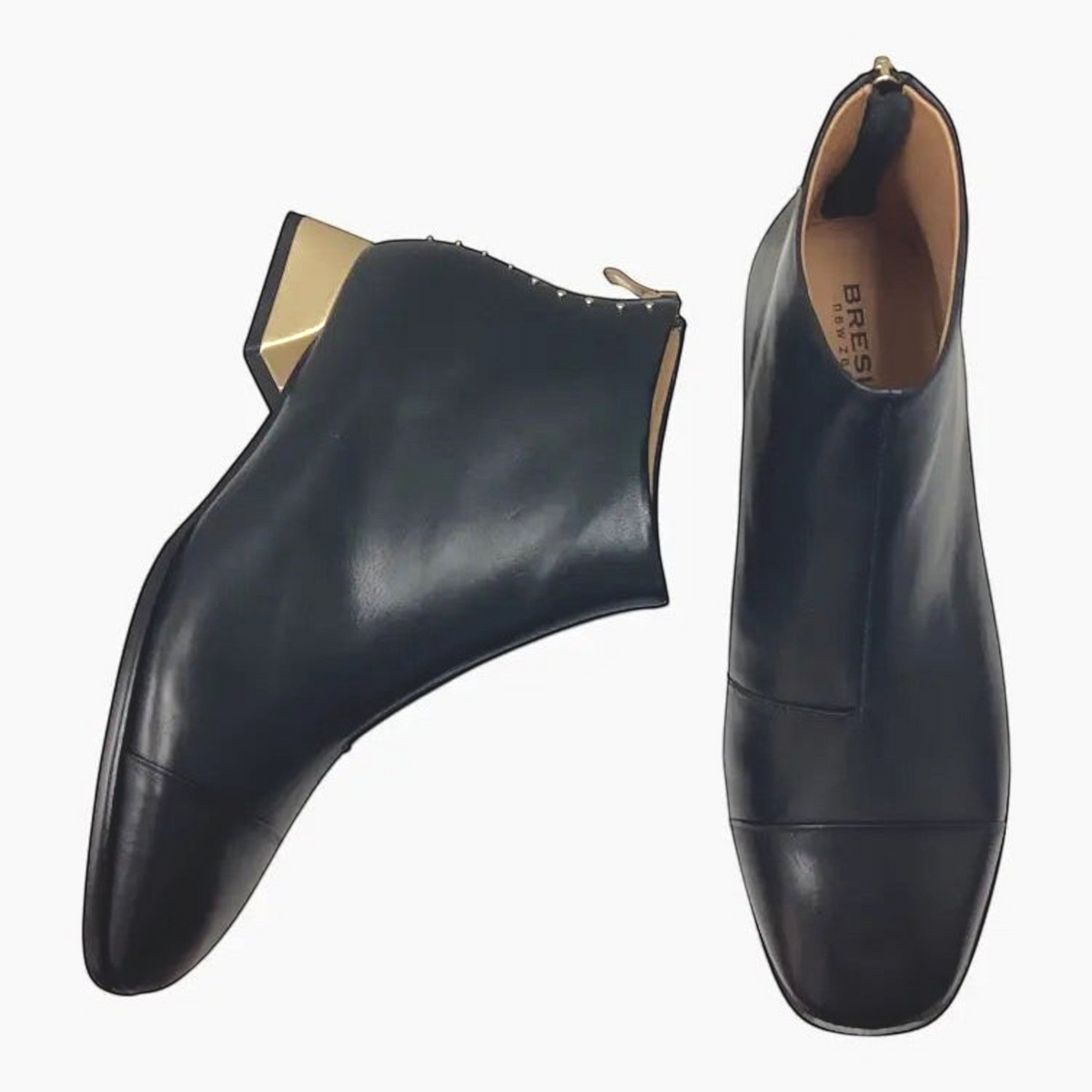 The Shoe Shop Bresley Demon black leather ankle boots with gold-tone block heels and metallic stud detailing.