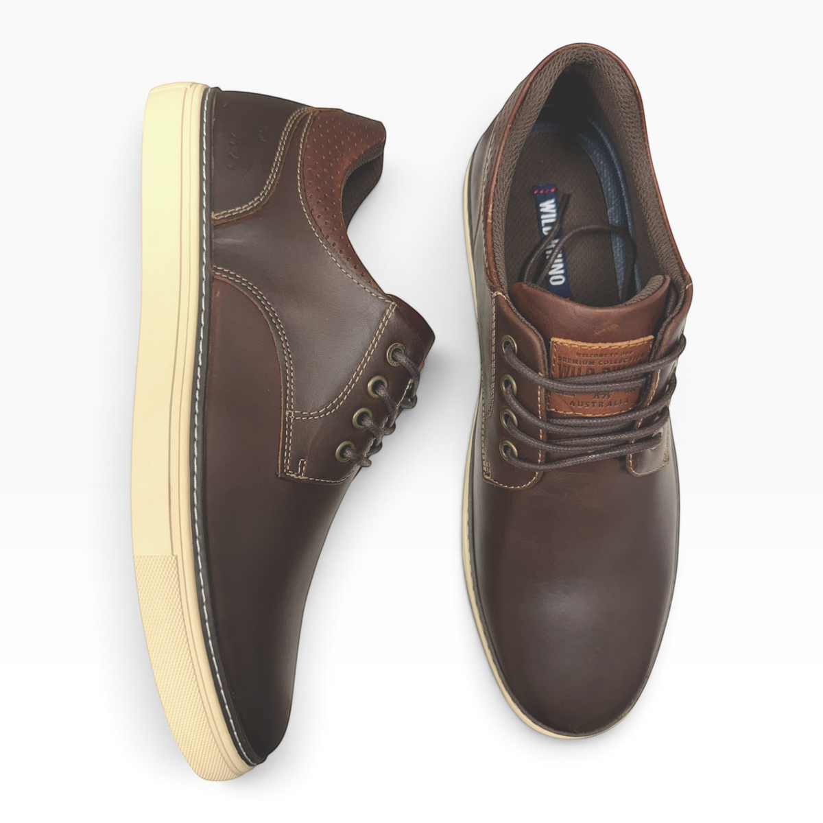 The Shoe Shop Border men's dark brown full-grain leather sneakers with embossed heel detail and cream rubber outsole.