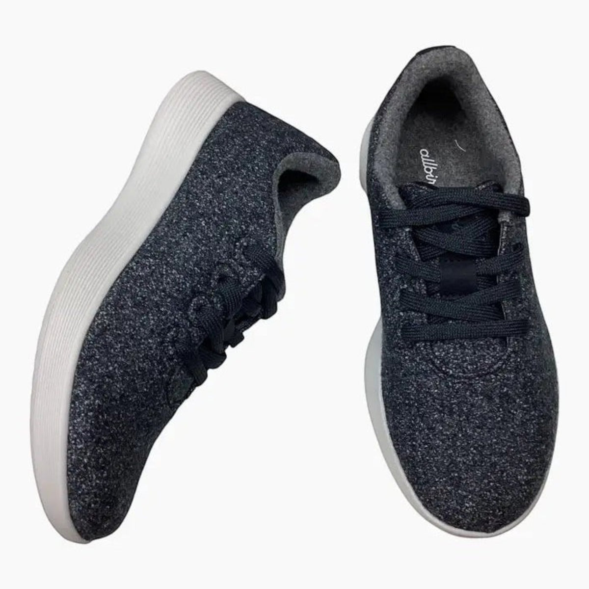 The Shoe Shop Wool Runner sneaker in charcoal grey Merino wool with a white cushioned sole and lace-up design.