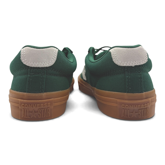 The Shoe Shop Converse green canvas low sneakers with gum rubber outsoles and grey heel tabs, rear view.