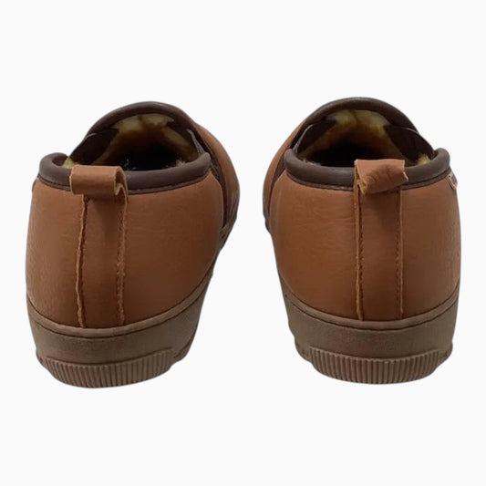 The Shoe Shop Tamarac deerskin leather slippers in tan with a slip-on design, fleece lining, and rubber outsoles.