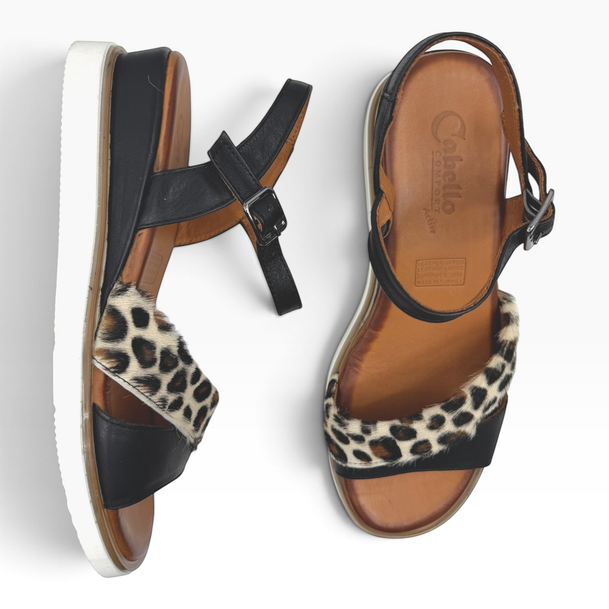 The Shoe Shop Eclipse leather wedge sandals featuring black straps and leopard-print detail with adjustable ankle strap