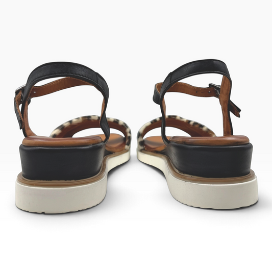 The Shoe Shop Eclipse sandals featuring leopard-print leather, black straps, and a supportive 5cm wedge heel.