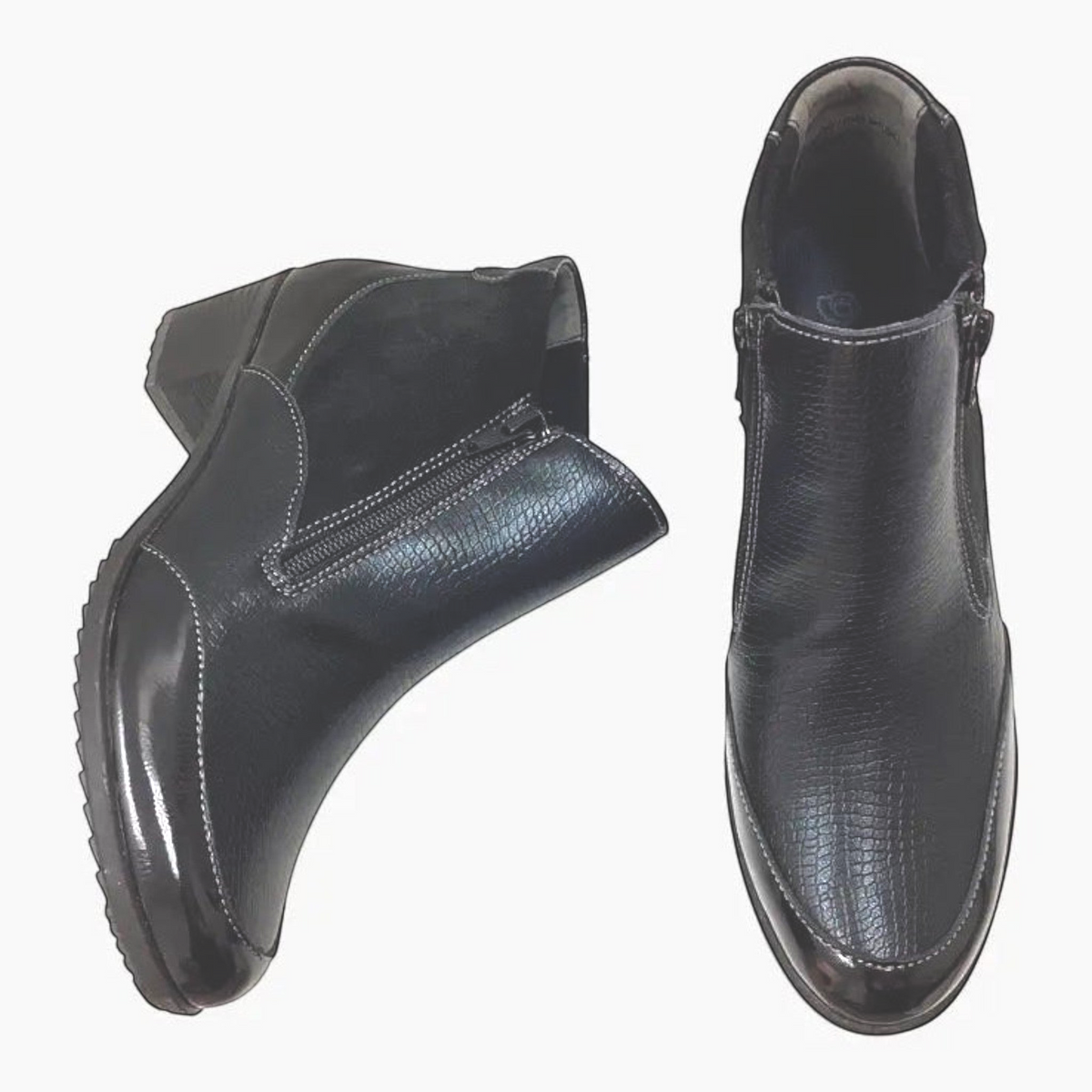 The Shoe Shop Emmi black ankle boots featuring a mix of smooth leather, suede, and patent textures with a block heel.
