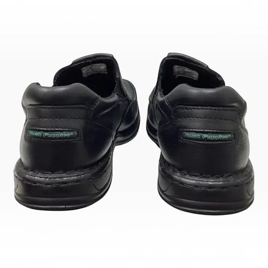 The Shoe Shop Hush Puppies Sawyer II black leather boat-style walkers showing the heel view with branded detailing.