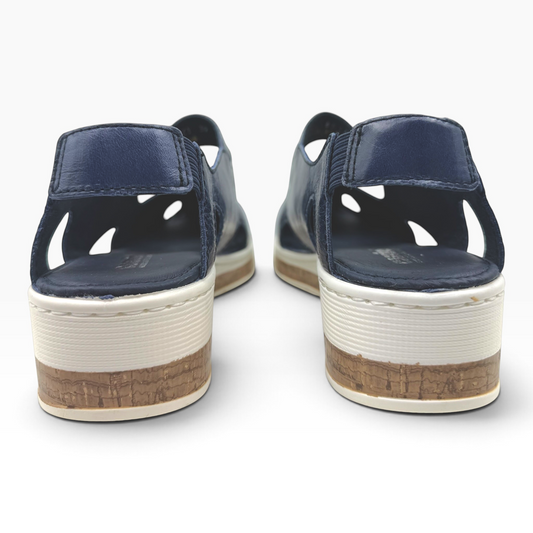 The Shoe Shop Maizy leather sandals in navy blue with a cushioned wedge heel and cork-effect midsole, back view.