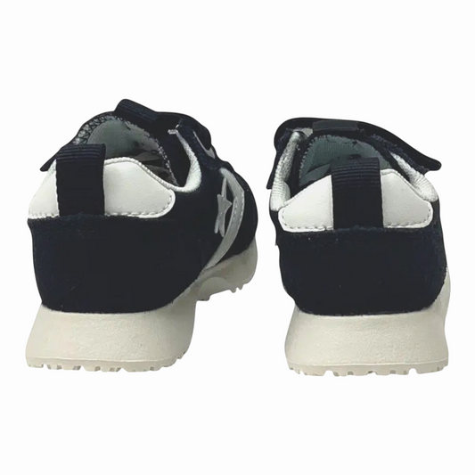 The Shoe Shop Omega Trainer OX infant sneakers in black suede with white heel tabs and foam midsoles, rear view.