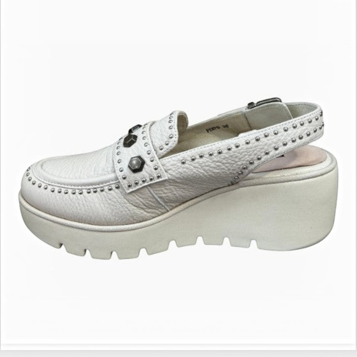 The Shoe Shop Peeps white leather wedge sandal with gunmetal stud detailing, buckle strap, and chunky lug sole.