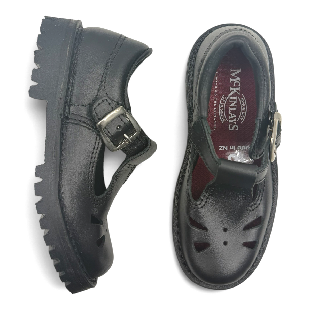 The Shoe Shop Rio black leather T-bar school shoes with durable rubber outsoles and buckle closure.