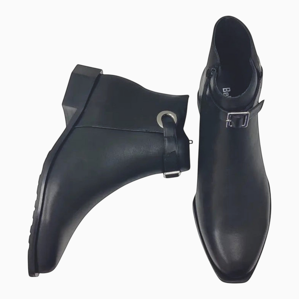 The Shoe Shop Roberta black leather ankle boots featuring a silver-tone ring, adjustable strap, and low block heel.