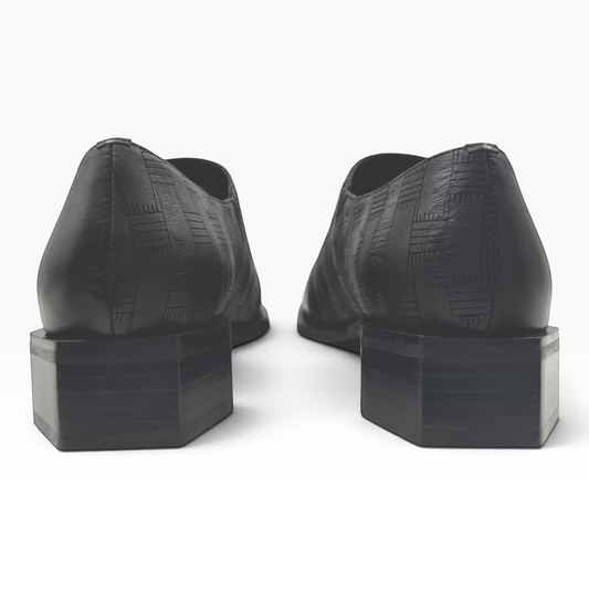 The Shoe Shop Romeo black textured leather loafers featuring a unique hexagonal heel, viewed from the back.