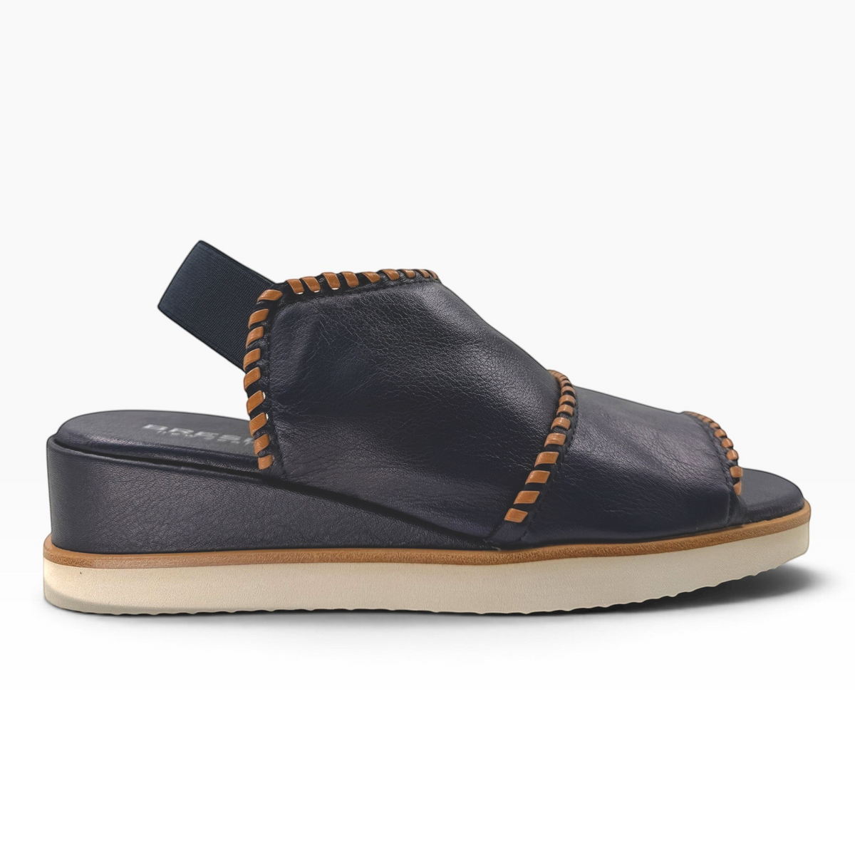 The Shoe Shop Sigma black leather wedge sandal with contrast tan whipstitching and an elasticated slingback strap.