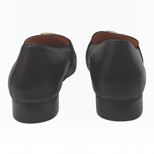The Shoe Shop Sinamon black leather loafers featuring a low stacked heel, viewed from the back.