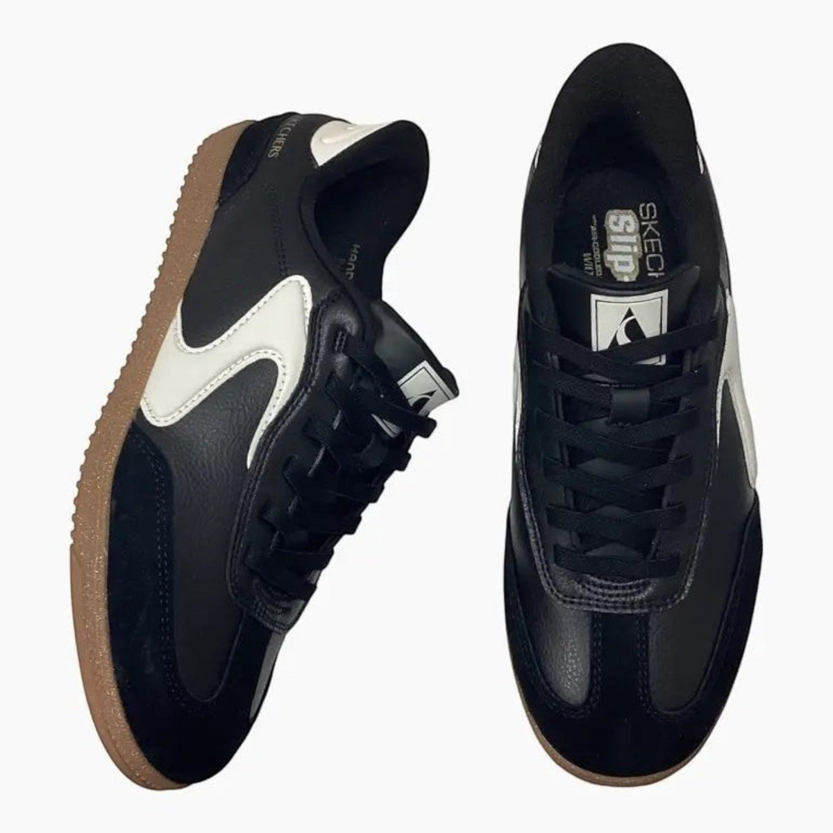 The Shoe Shop Skechers Hotshot black and white slip-on sneakers with suede overlays and gum rubber outsoles.