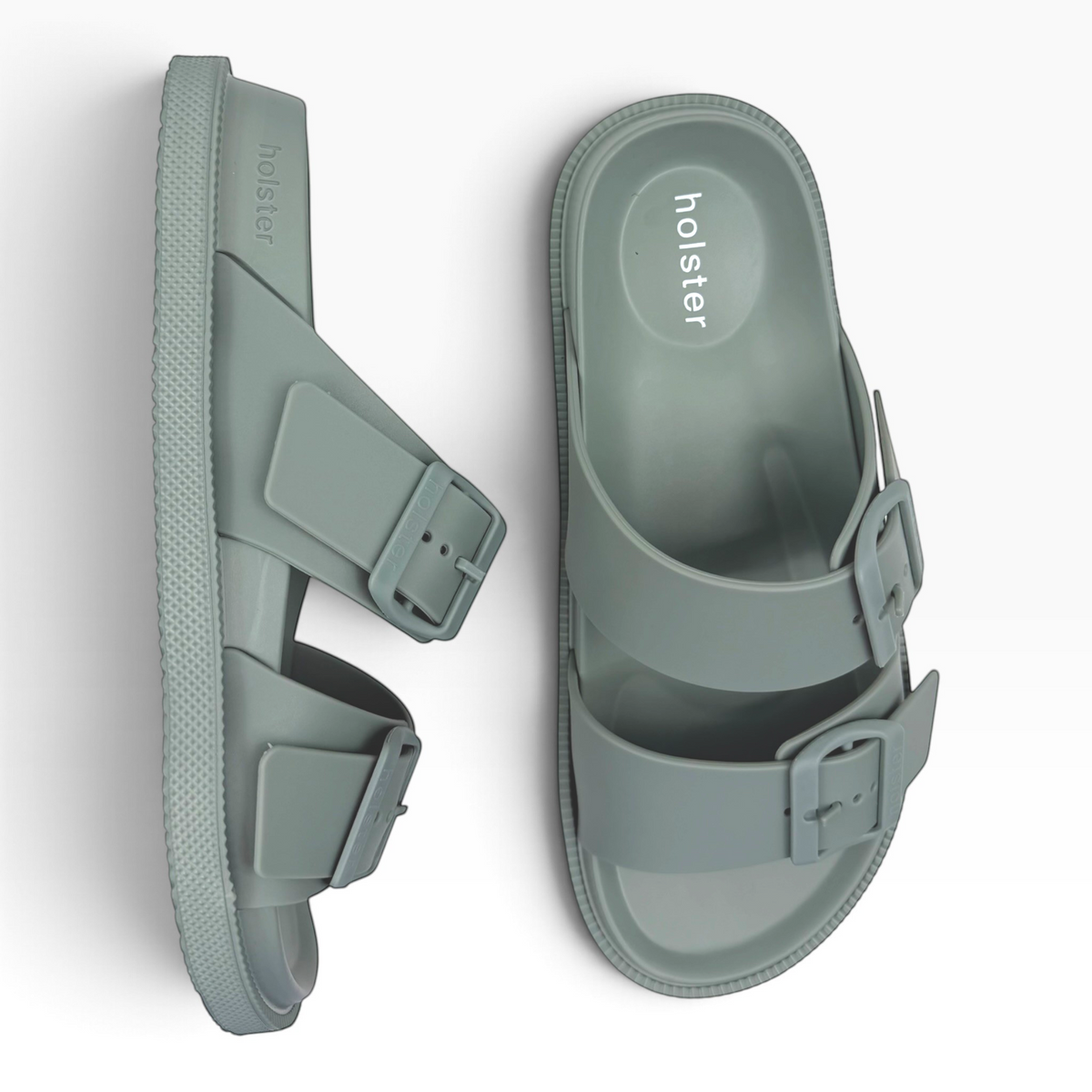 The Shoe Shop Soleseeker slide sandals in green with adjustable buckle straps and a cushioned footbed.