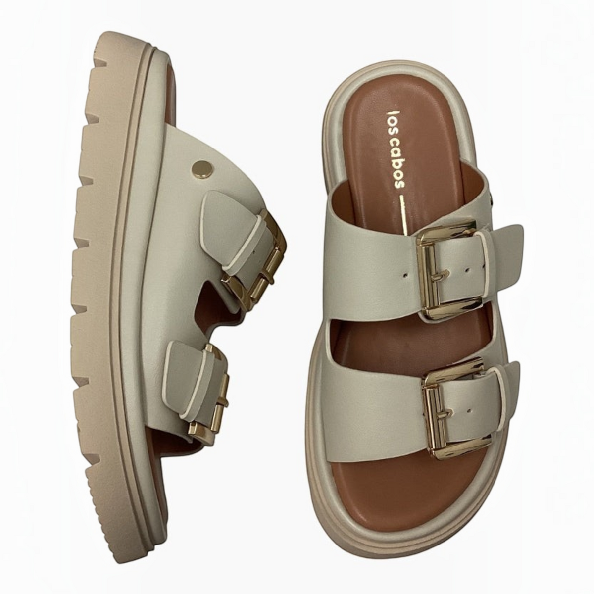 The Shoe Shop Los Cabos Toledo beige slide sandals with twin gold buckle straps and a chunky platform lug sole.
