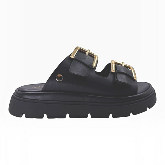 The Shoe Shop Toledo black slide sandals with twin adjustable buckle straps, gold hardware, and a chunky lug sole.