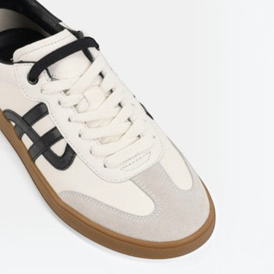 The Shoe Shop Trackside sneaker in cream suede and canvas with black detailing and a flexible gum rubber outsole.