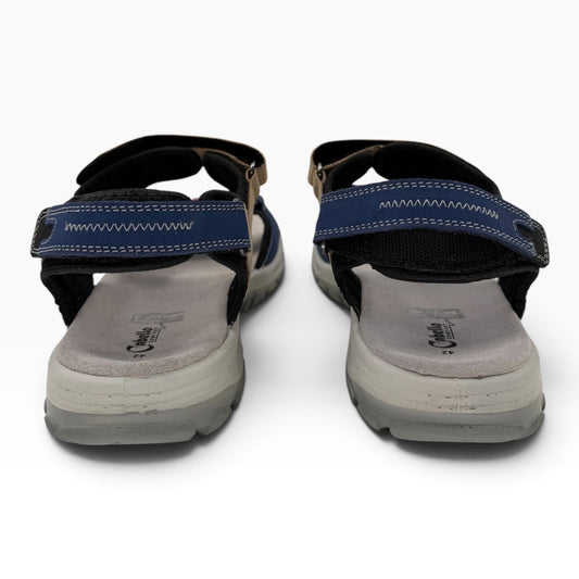 The Shoe Shop Trek sandals featuring blue and tan textile straps, moulded footbeds, and adjustable Velcro closures.