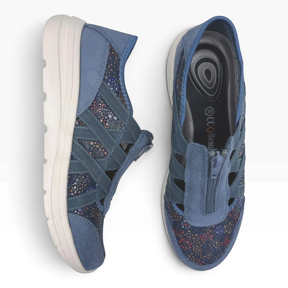 The Shoe Shop Callum Casual Flat in blue suede with floral textile details, elasticated straps, and a zip-up front.