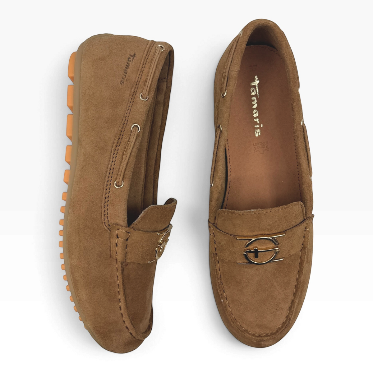 The Shoe Shop 24630 cognac suede loafers with gold-tone hardware and flexible rubber driving soles, top-down view.