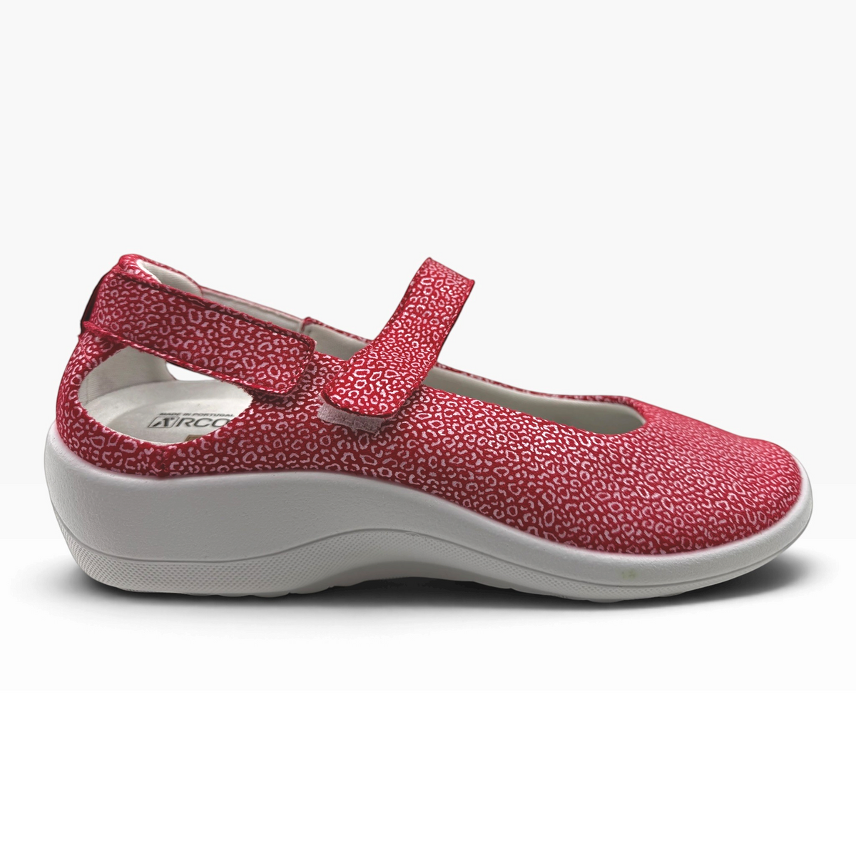 The Shoe Shop Minami red Mary Jane comfort shoe with flexible elastic upper, Velcro strap, and lightweight wedge sole.