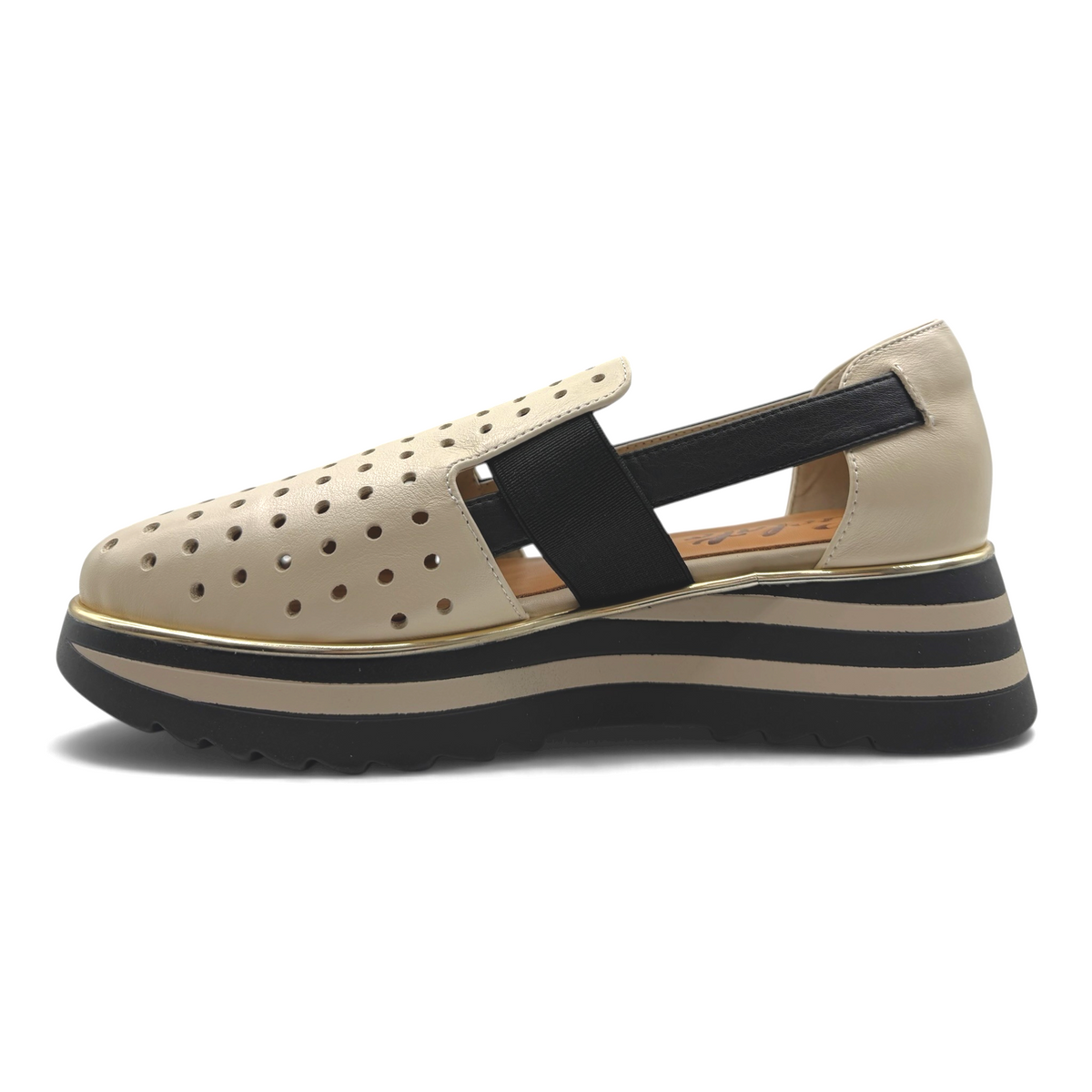 The Shoe Shop Gelato Gap beige perforated slip-on flat with black elastic strap and striped platform sole.