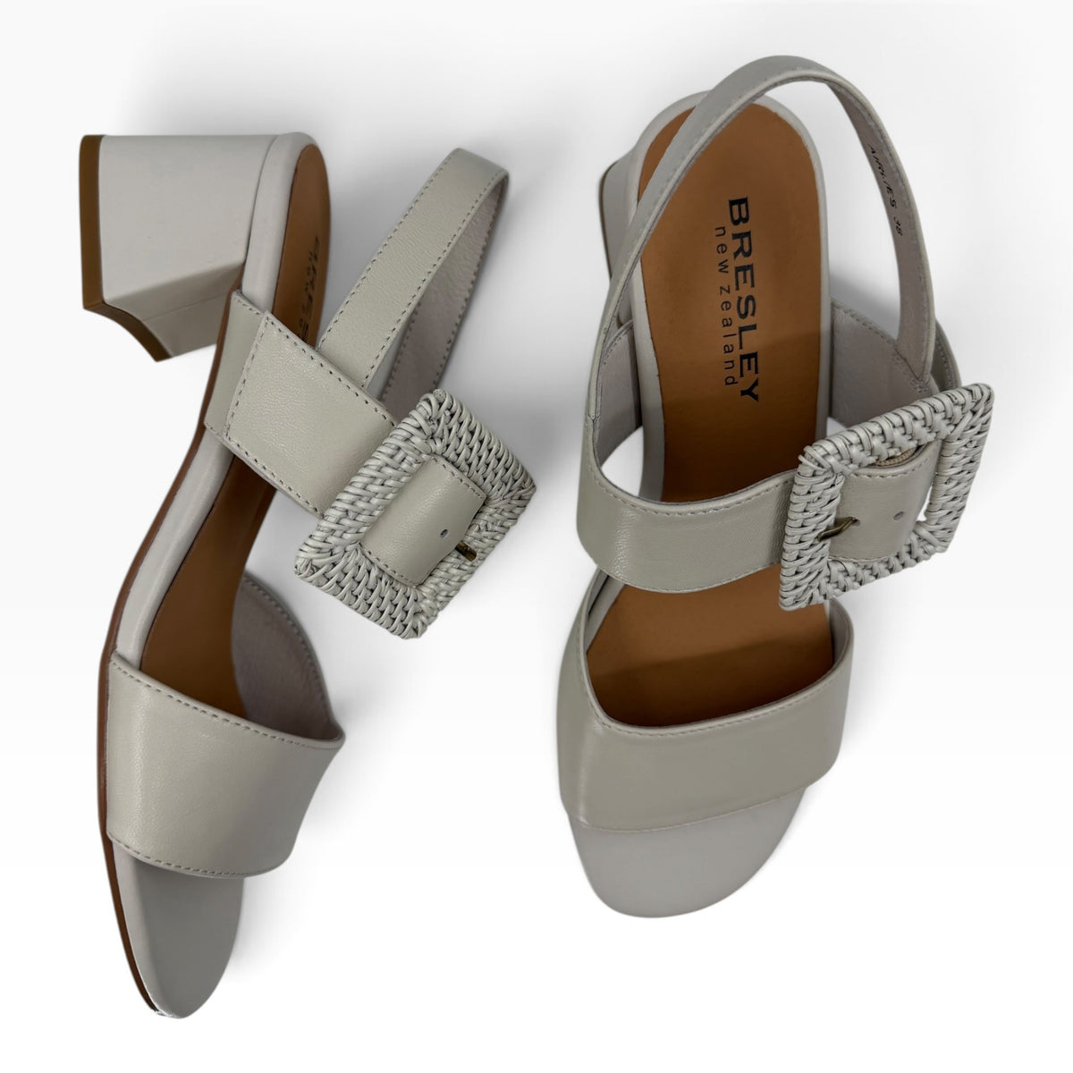 The Shoe Shop Airlies light grey leather block heel sandals featuring a decorative woven buckle strap