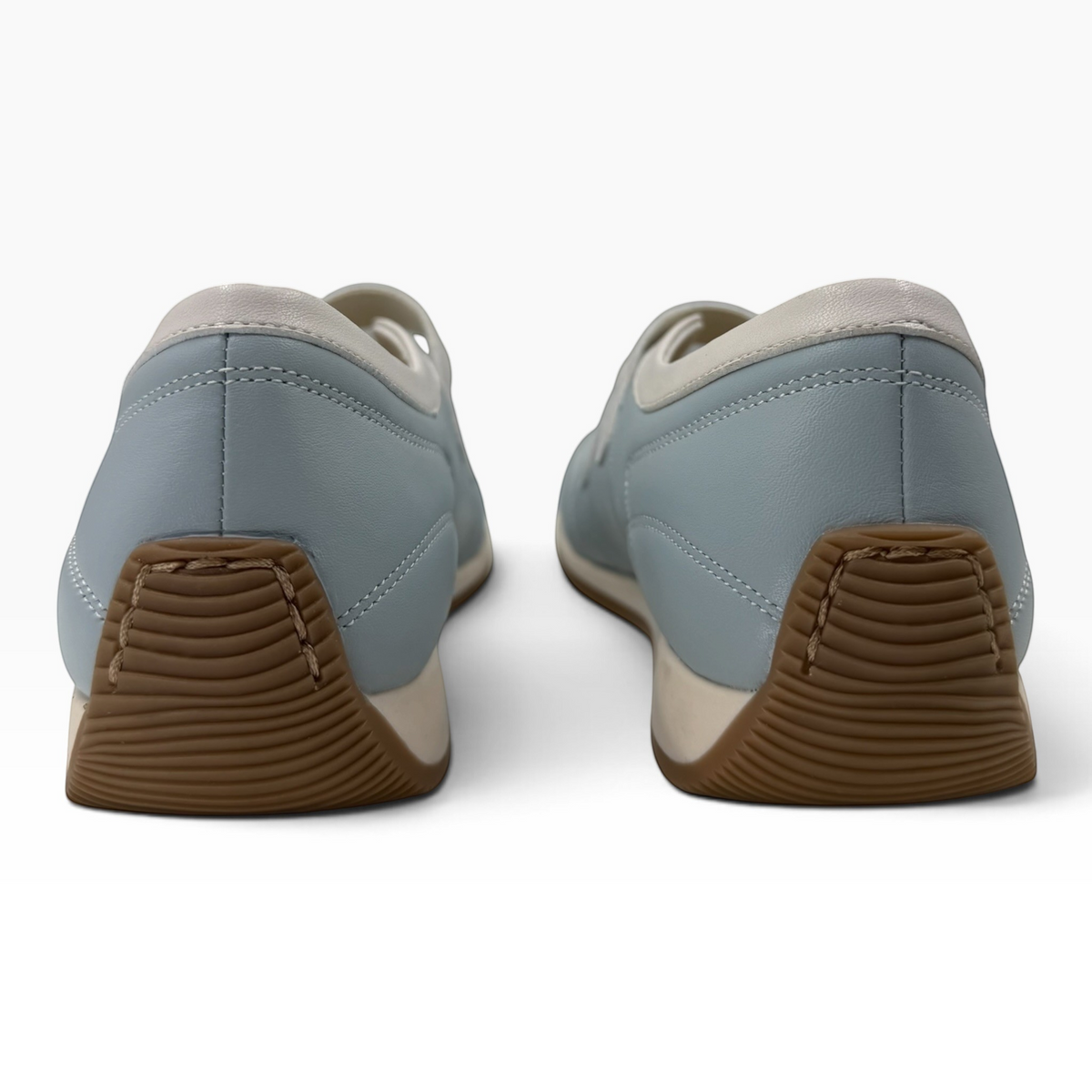 The Shoe Shop Amor flat in light blue leather with a brown rubber sole, shown from the back view.