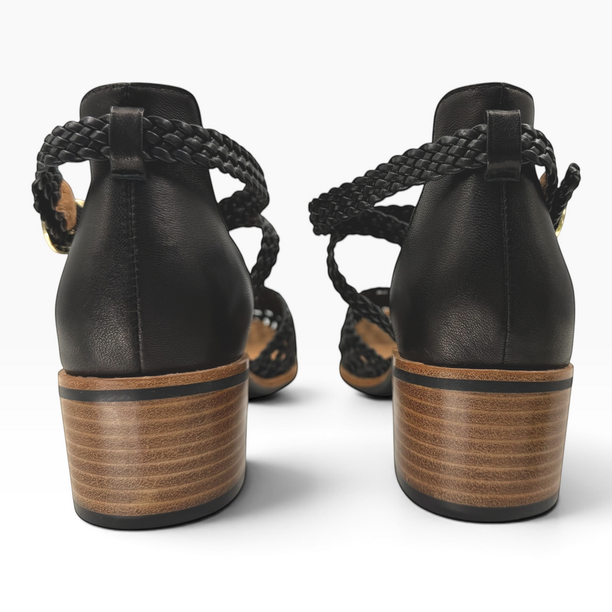 Back view of The Shoe Shop Anglo black leather sandals featuring a braided ankle strap and a stacked wooden block heel.