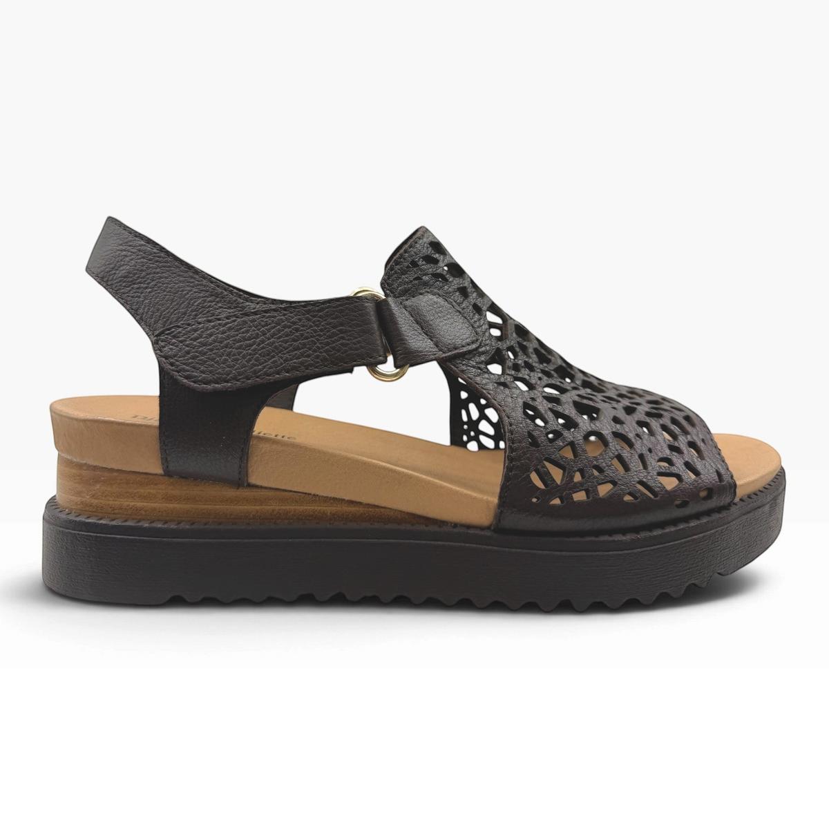 The Shoe Shop Ansh platform sandal in black leather with intricate laser-cut floral patterns and a beige footbed.