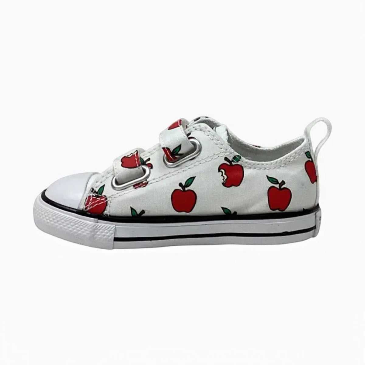 The Shoe Shop Chuck Taylor All Star toddler sneakers in white canvas with a playful red apple print and velcro straps.