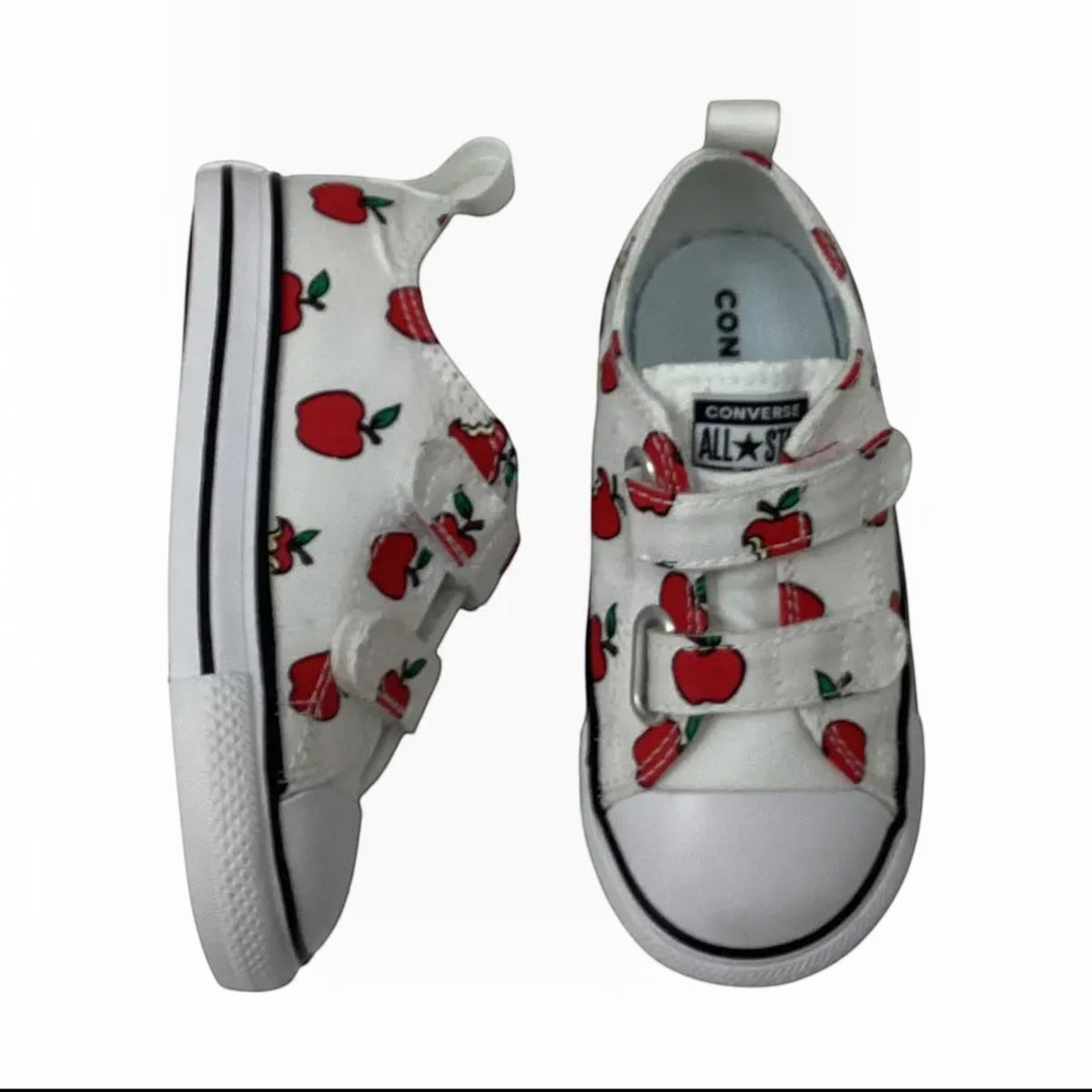 The Shoe Shop Converse Chuck Taylor All Star toddler sneakers in white canvas with a red apple print and velcro straps