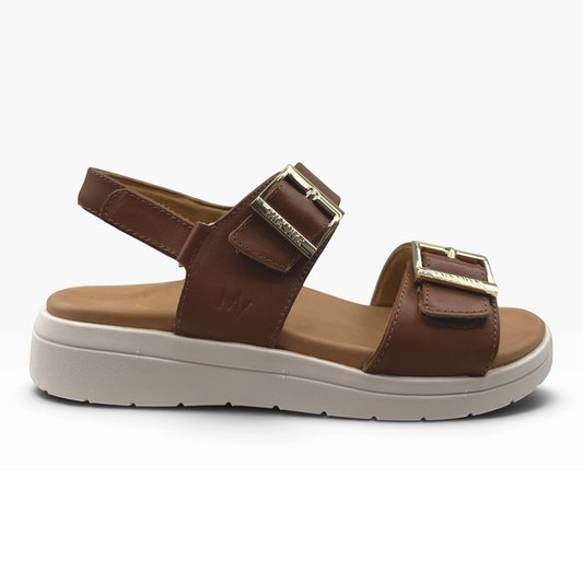 The Shoe Shop Bettina sandal in brown leather with adjustable straps, gold buckles, and a thick white platform sole.