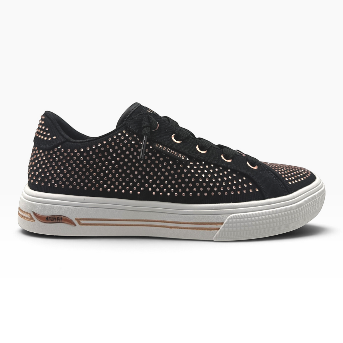 The Shoe Shop Skechers Arch Fit Arcade Gem Steps black canvas sneaker with rose gold metallic stud detailing.