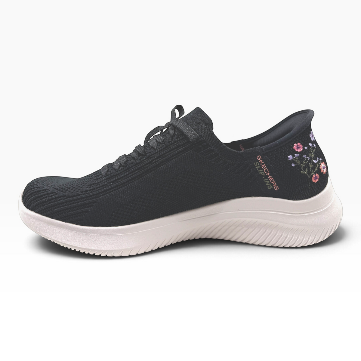 The Shoe Shop Skechers Ultra Flex 4.0 black slip-on sneaker with floral embroidery and white cushioned sole.