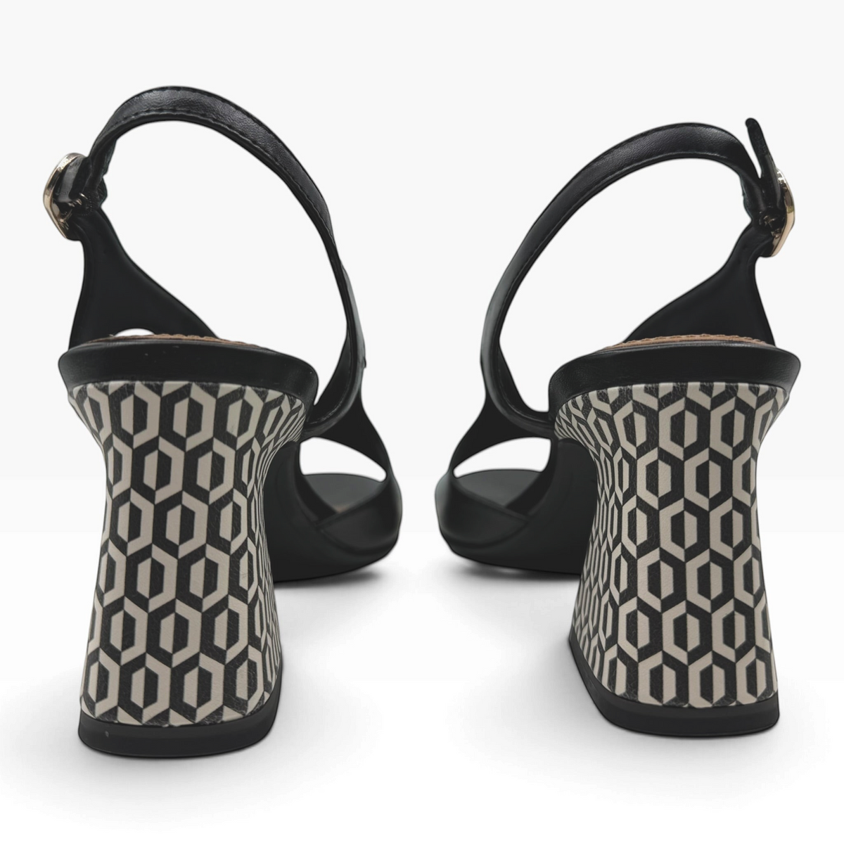 The Shoe Shop 28316 black leather slingback sandals featuring a sculptural block heel with geometric pattern