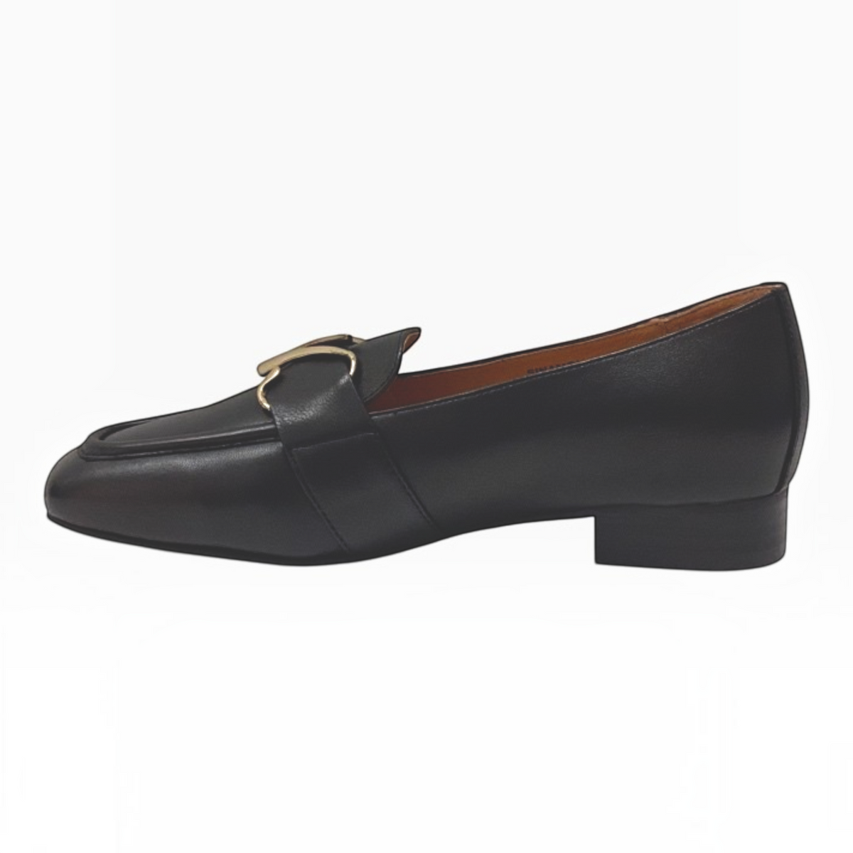 The Shoe Shop Sinamon black leather loafer with a gold-tone buckle, stitched apron front, and low stacked heel.
