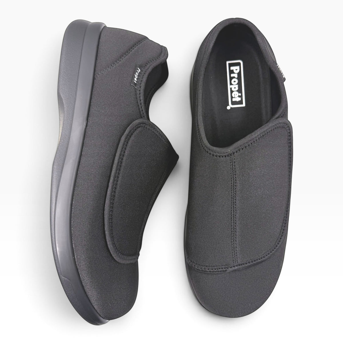 The Shoe Shop Cush n Foot black neoprene slippers with adjustable hook-and-loop straps and durable PU outsoles.