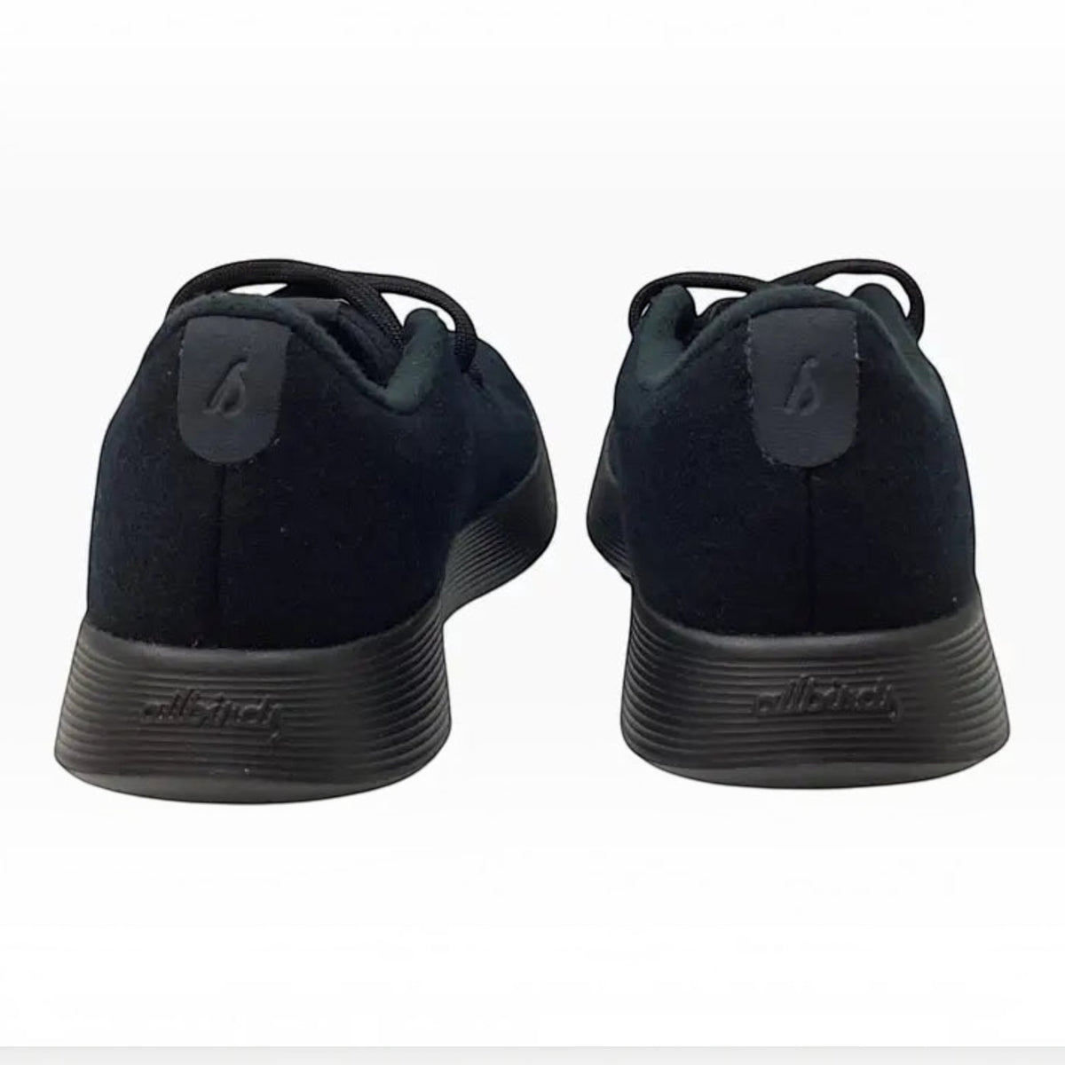 The Shoe Shop Allbirds black Merino wool runner sneakers viewed from the back showing cushioned soles