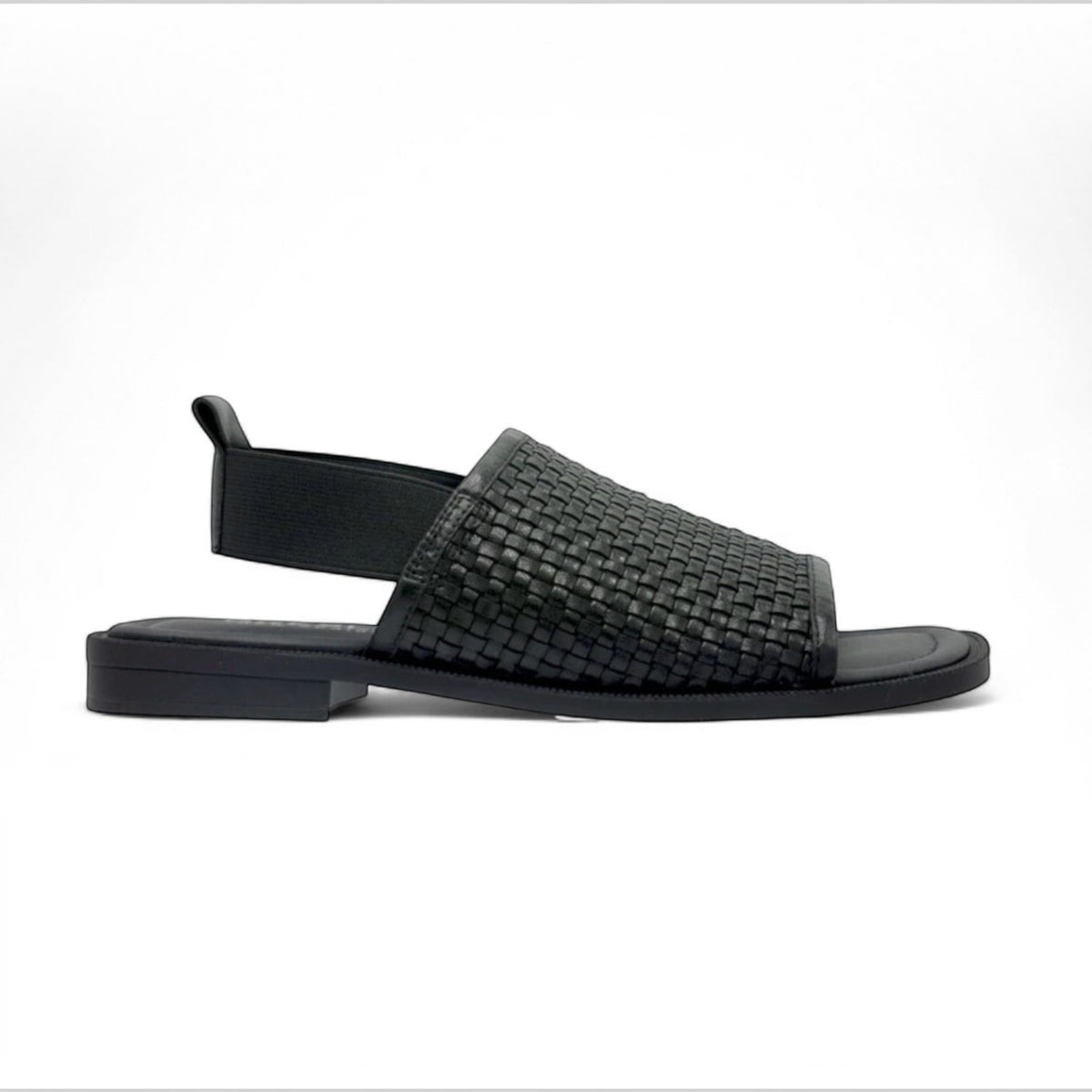 The Shoe Shop Snob black leather woven slingback sandal with a flat sole and comfortable slip-on design.