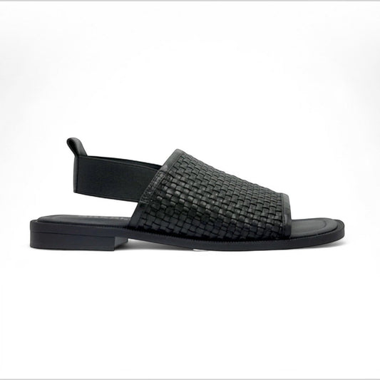 The Shoe Shop Snob black leather woven slingback sandal with a flat sole and comfortable slip-on design.