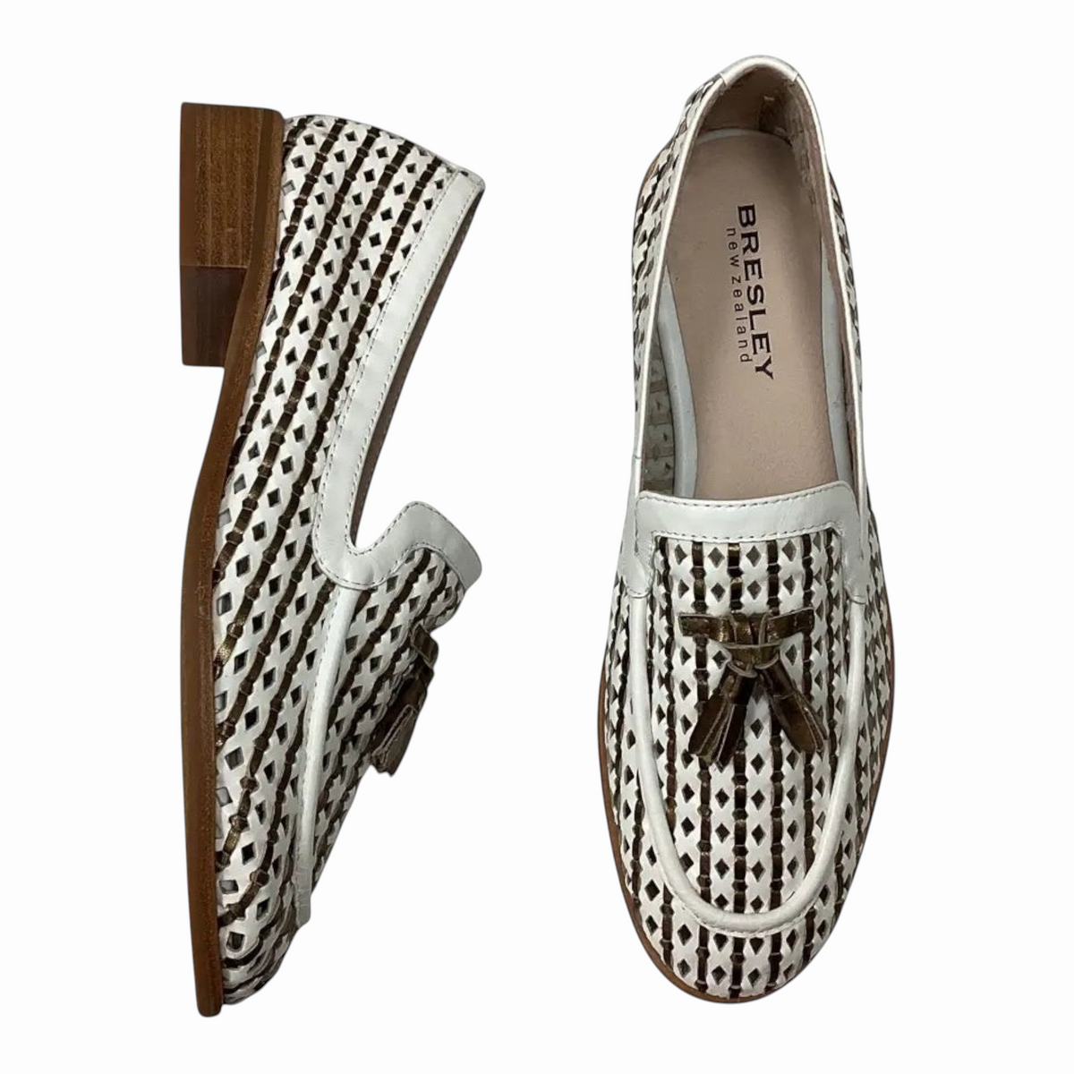 The Shoe Shop Bresley gilded leather loafers featuring a white and brown woven pattern with gold tassel detailing.