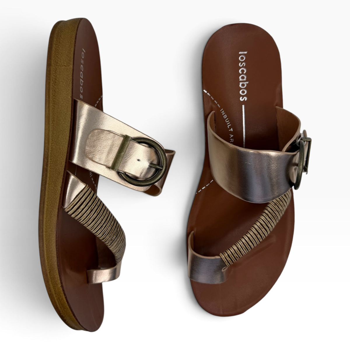 The Shoe Shop Bria metallic gold sandals with bamboo-wrapped toe strap and antique buckle detail on a flexible sole.