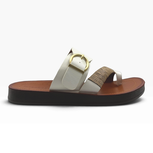 The Shoe Shop Bria Wide white slide sandal with a gold buckle and textured strap detail on a brown platform sole.