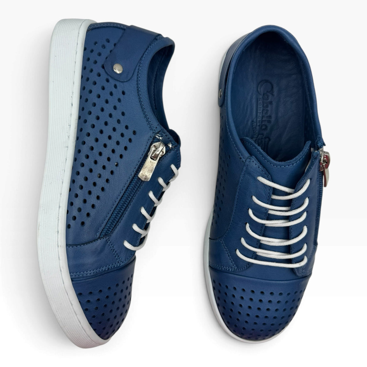 The Shoe Shop Cabello EG17 blue leather sneakers with punched upper, side zip, and white laces on a white background.