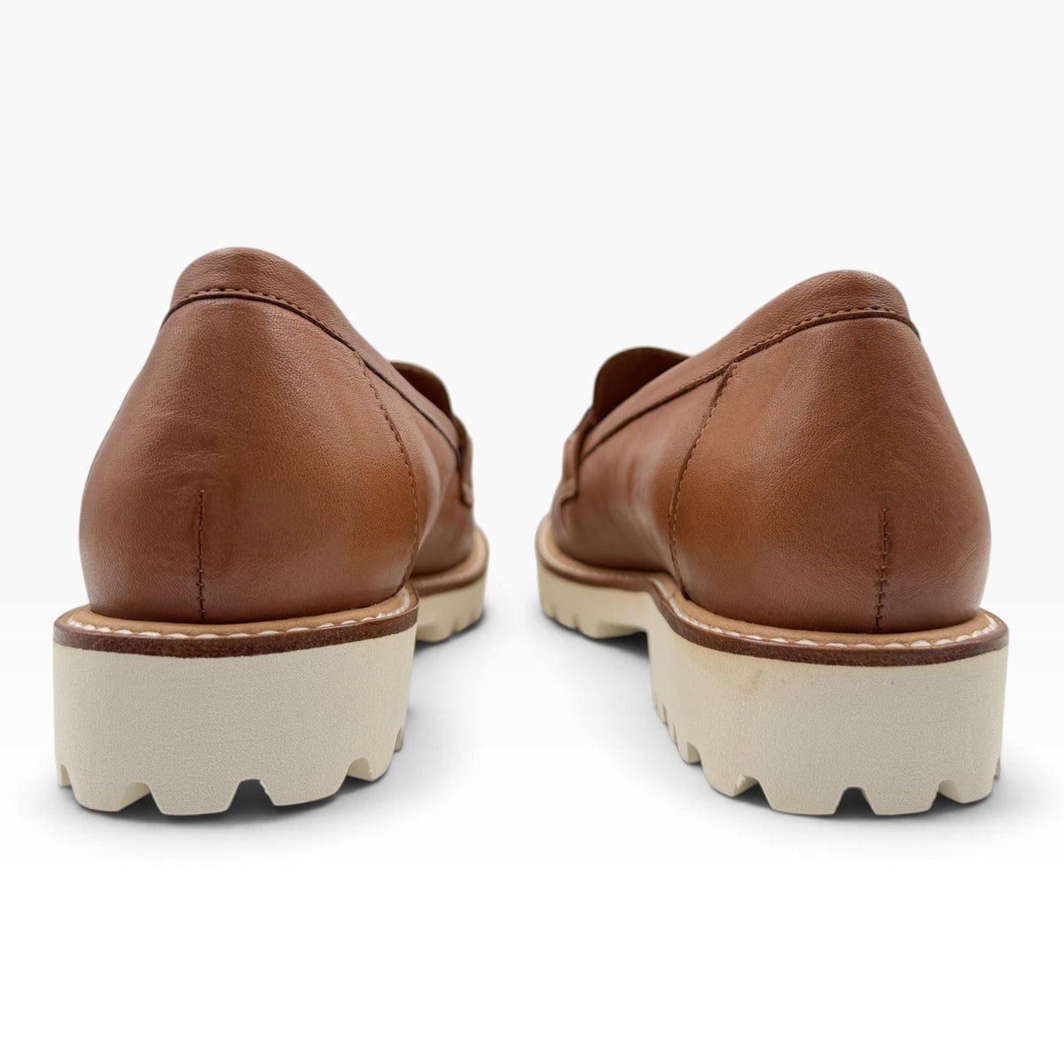 The Shoe Shop Cassini brown milled leather loafers with a thick white rubber lug sole, back view.