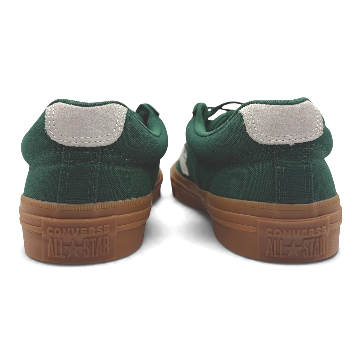 The Shoe Shop Converse green canvas low sneakers with gum rubber outsoles and grey heel tabs, rear view.
