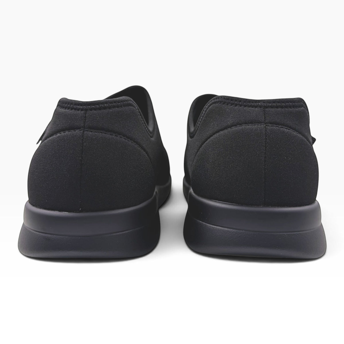 The Shoe Shop Cush n Foot M 5E black neoprene slippers viewed from the back showing the durable PU outsole